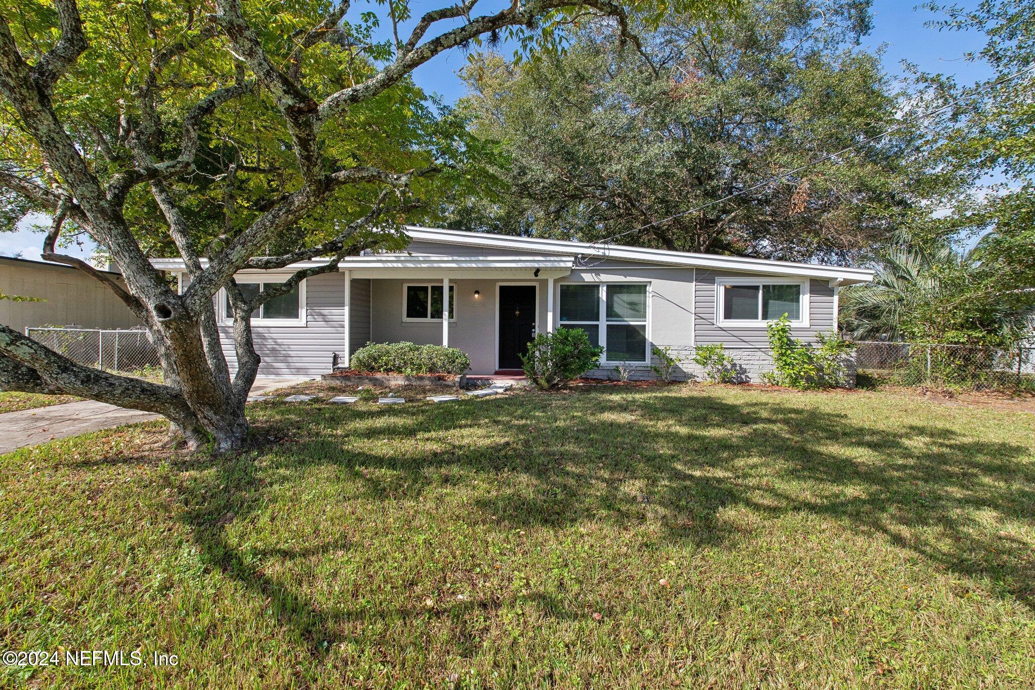 a front view of house with yard and green space