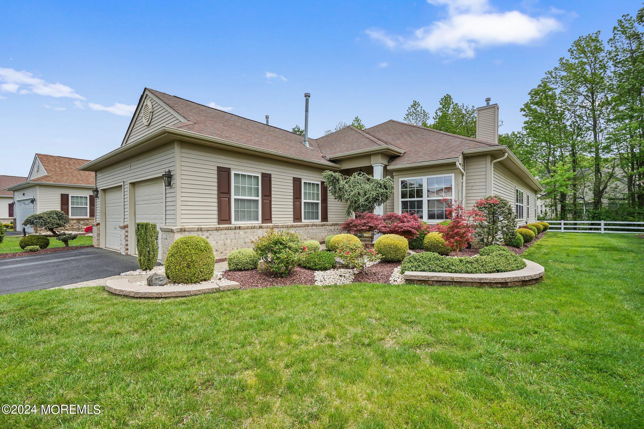 a front view of house with yard and green space