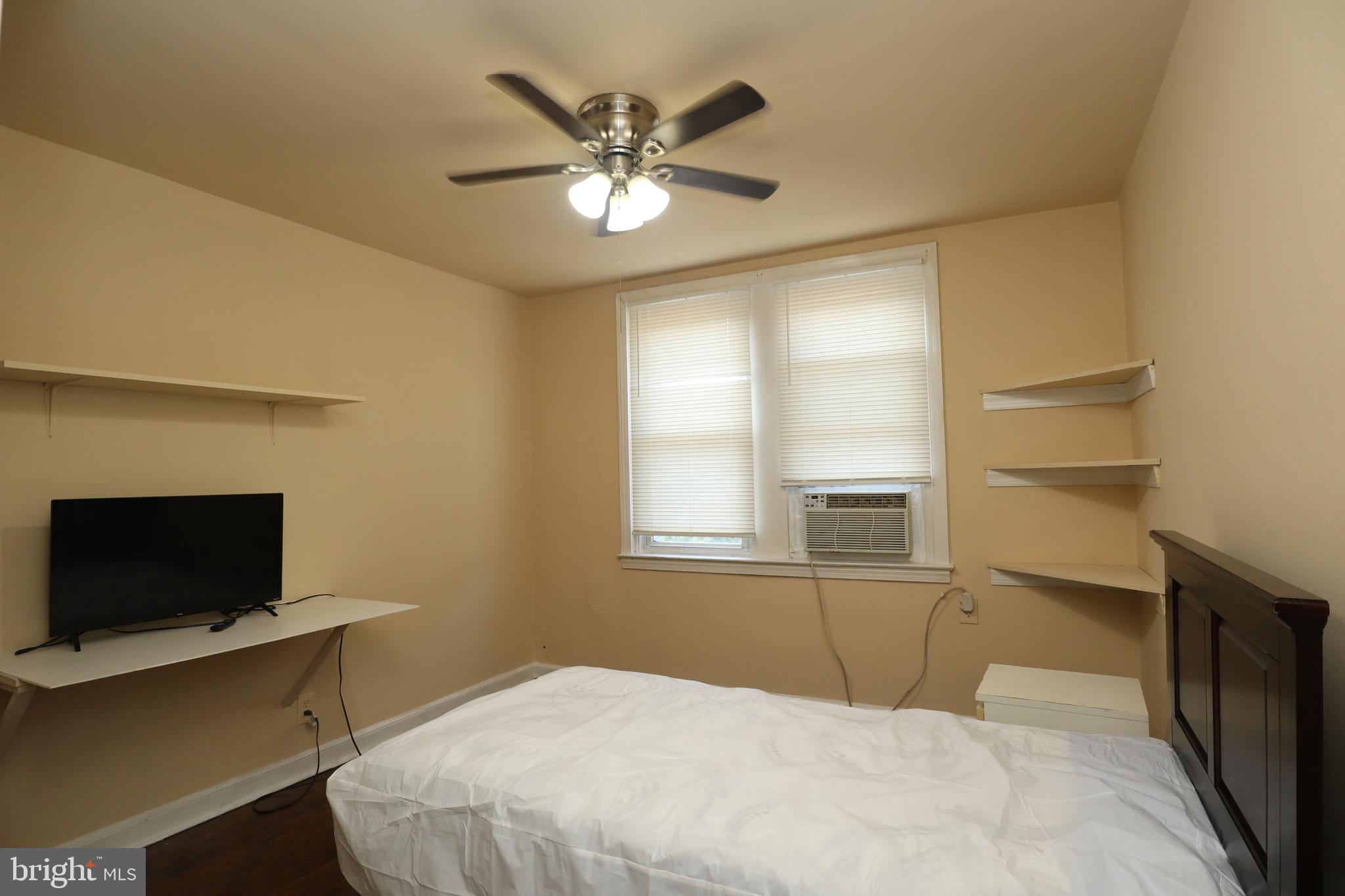 a bedroom with a large bed and a tv