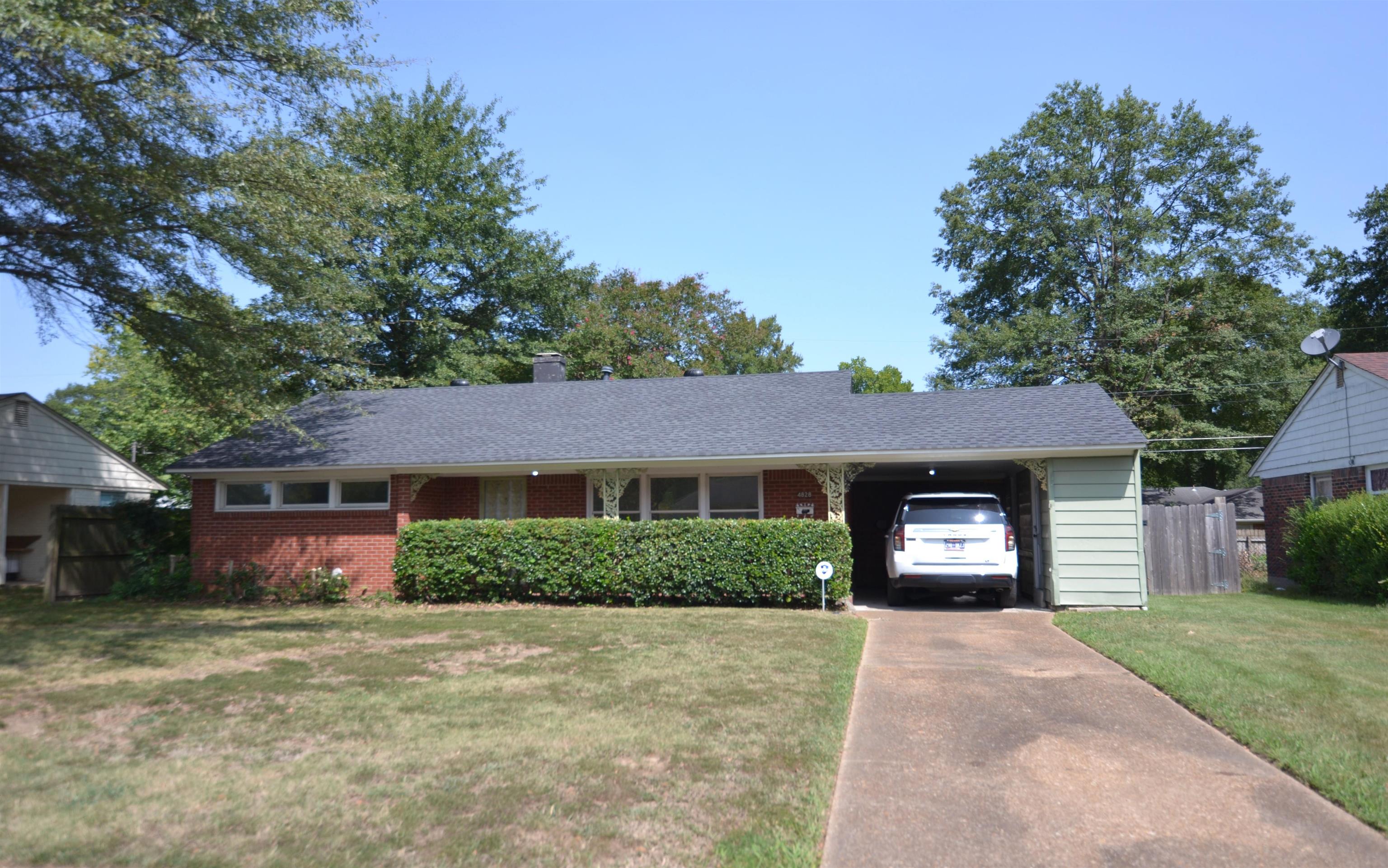 a front view of a house with a yard and a garage