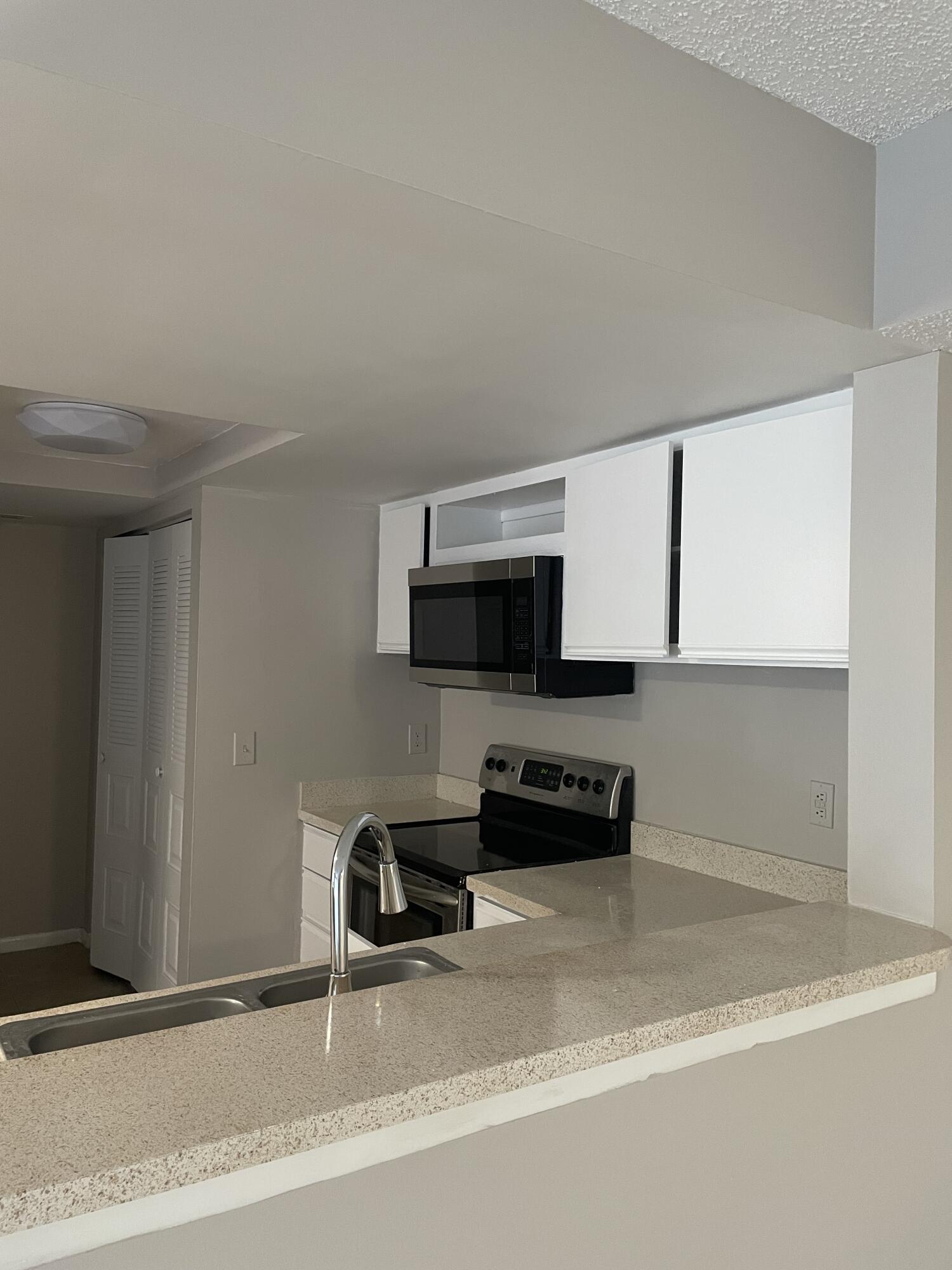 a kitchen with a sink and a stove top oven