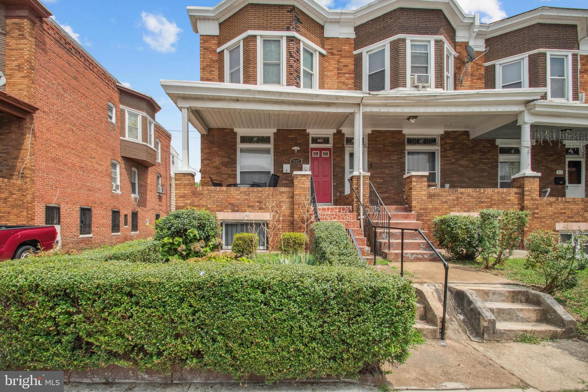 front view of a brick house with a yard