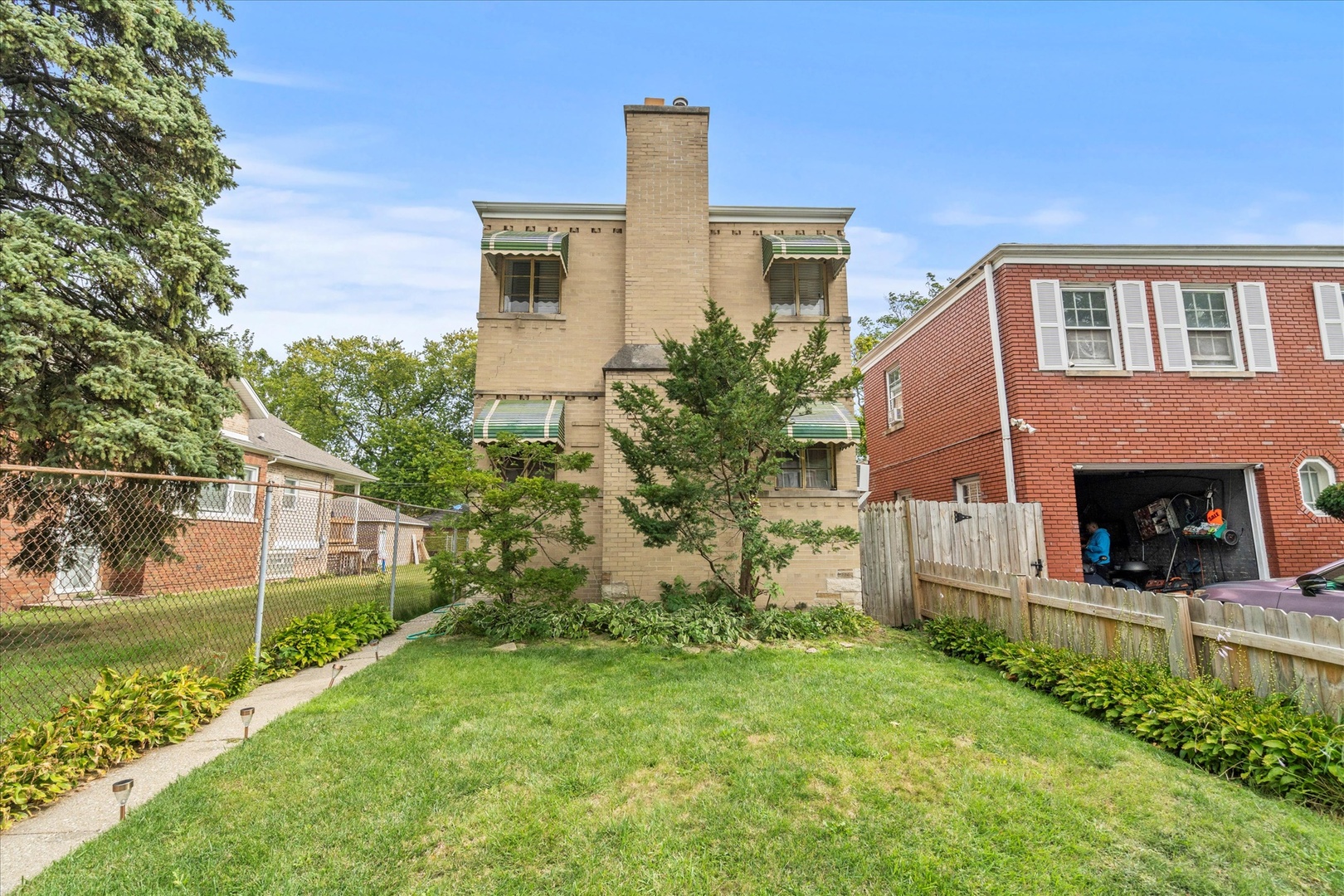 a front view of a house with yard and staircase