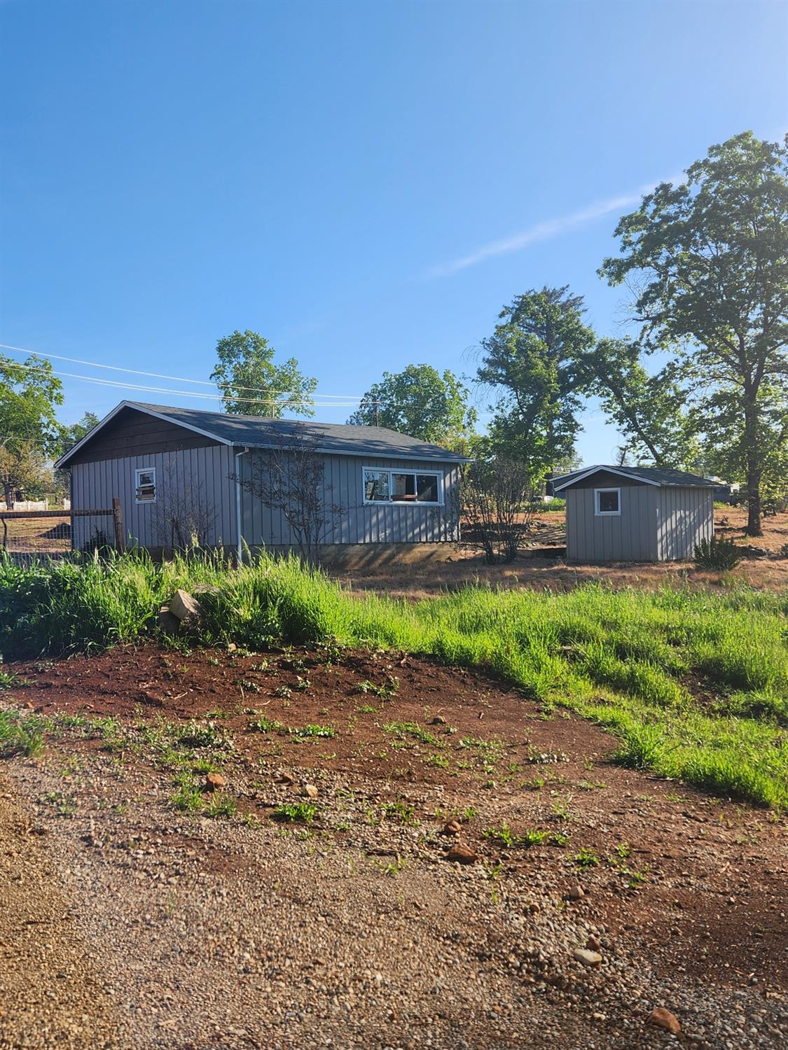 a view of a yard with a house in the background