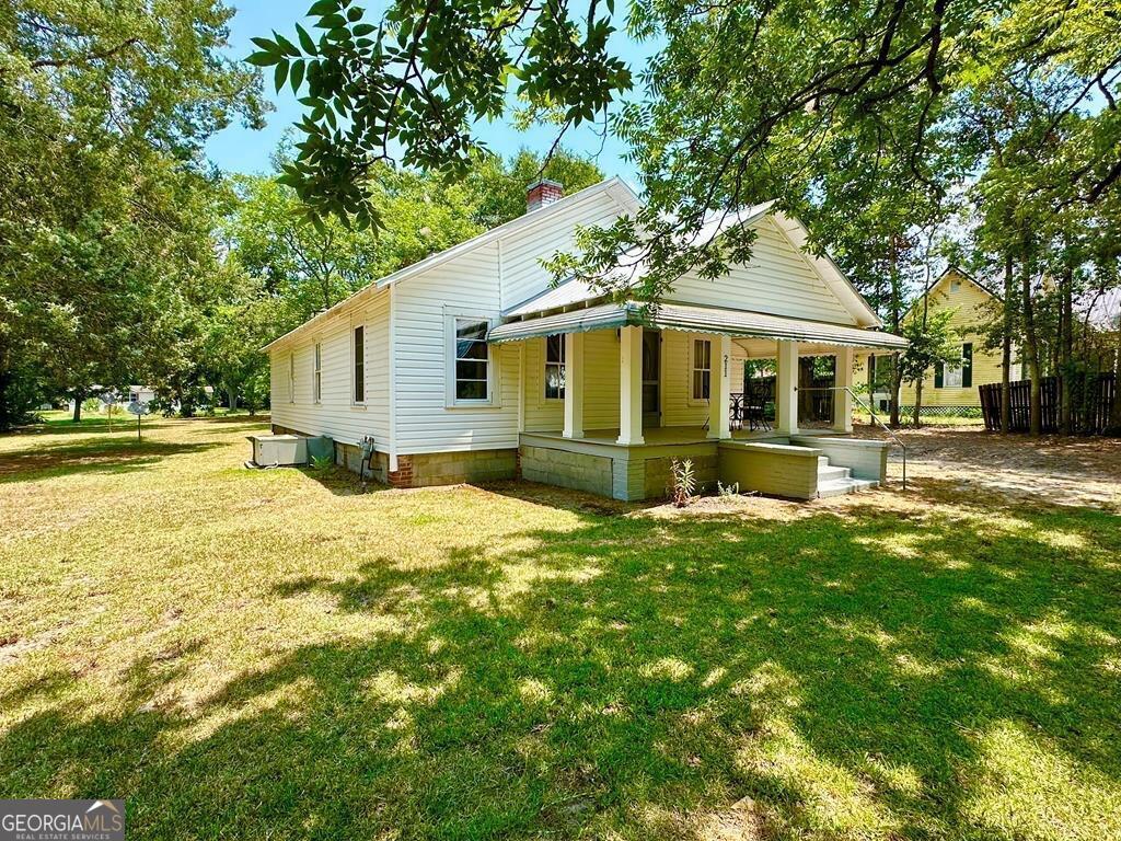 a front view of a house with yard and green space