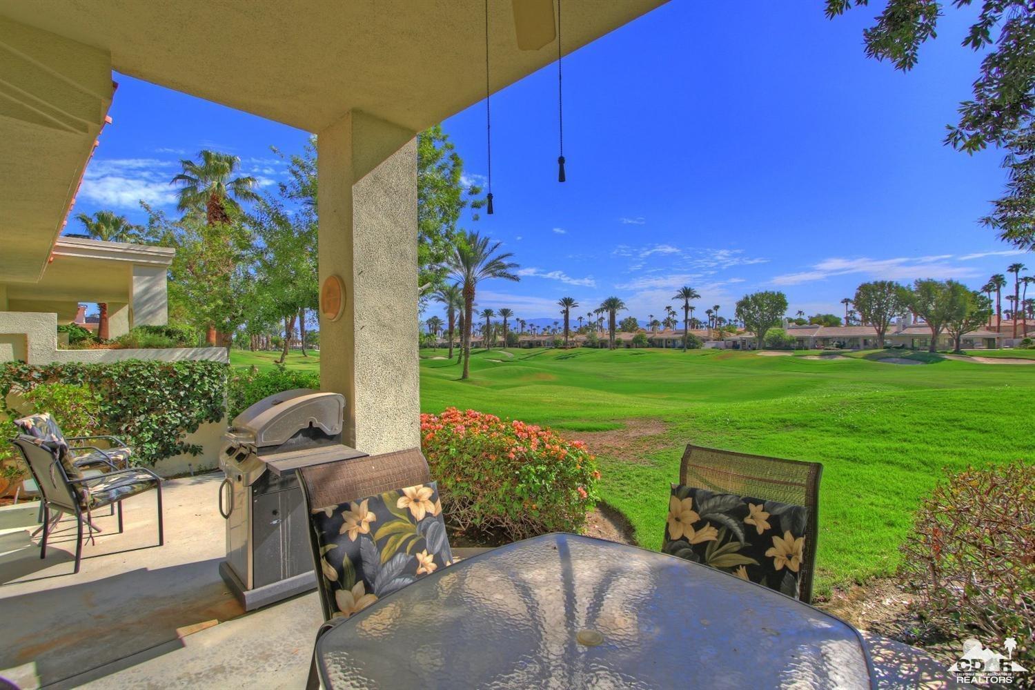 a view of a house with backyard porch and sitting area