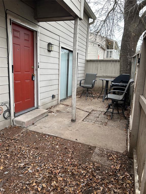 Front door and patio area behind front gate