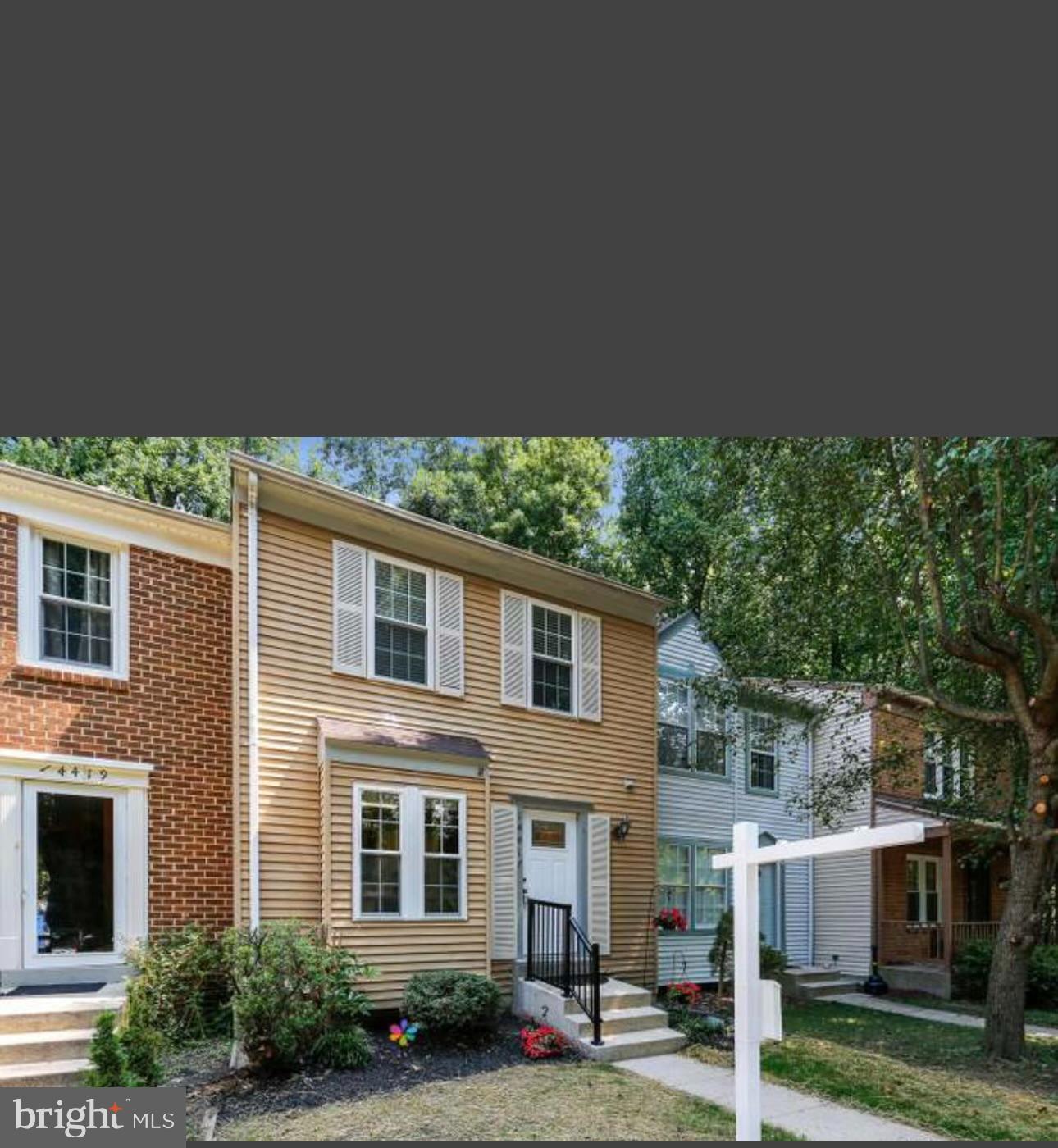 a front view of a residential houses with yard