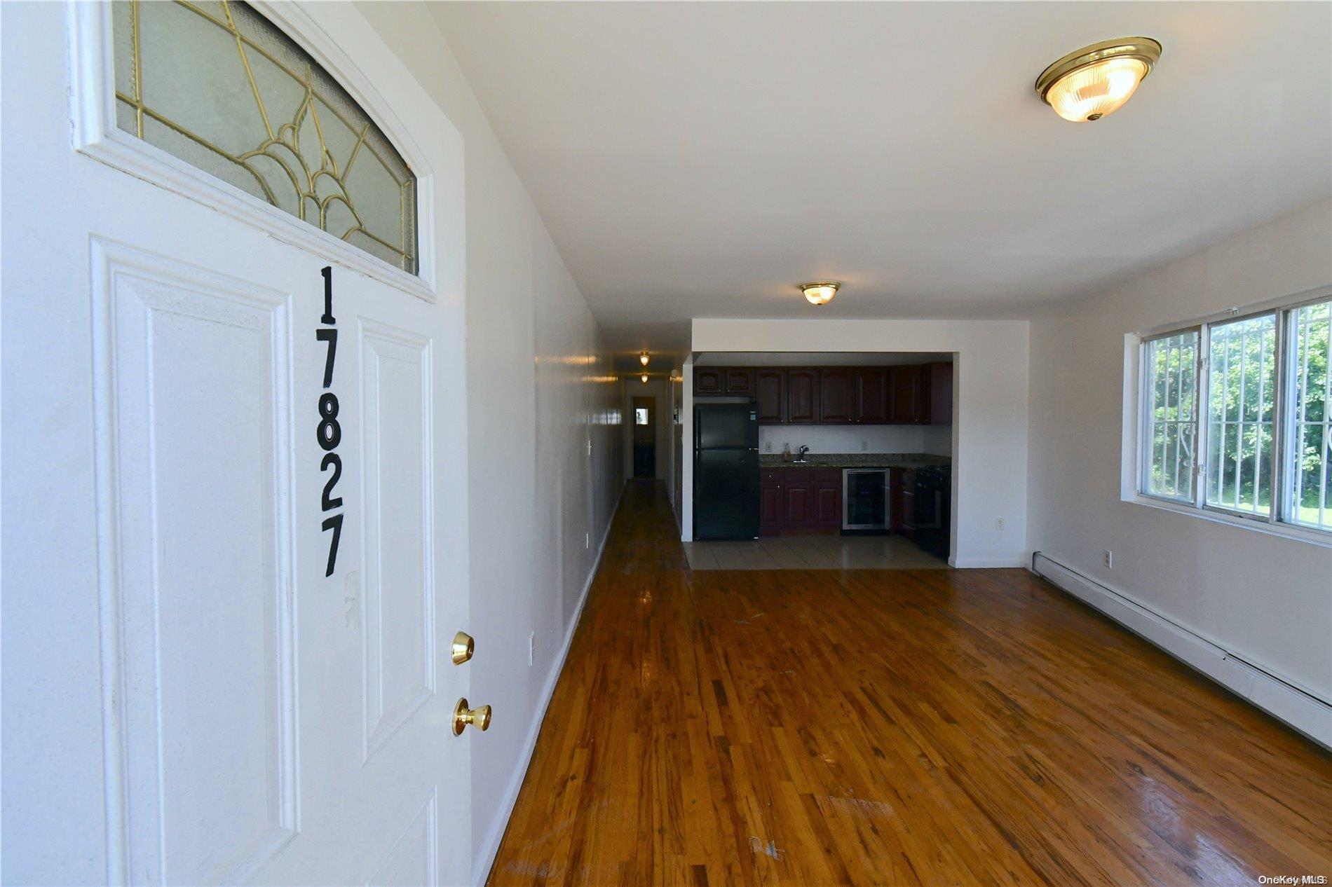 a view of a hallway view with wooden floor and staircase