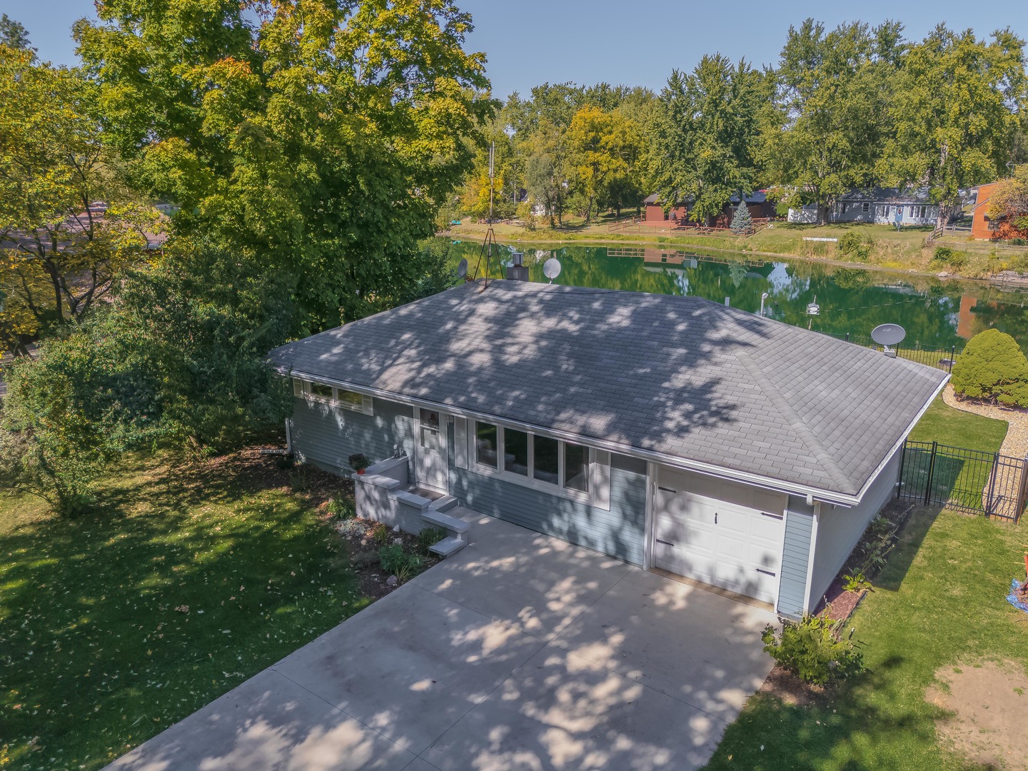 a view of house with river and outdoor seating