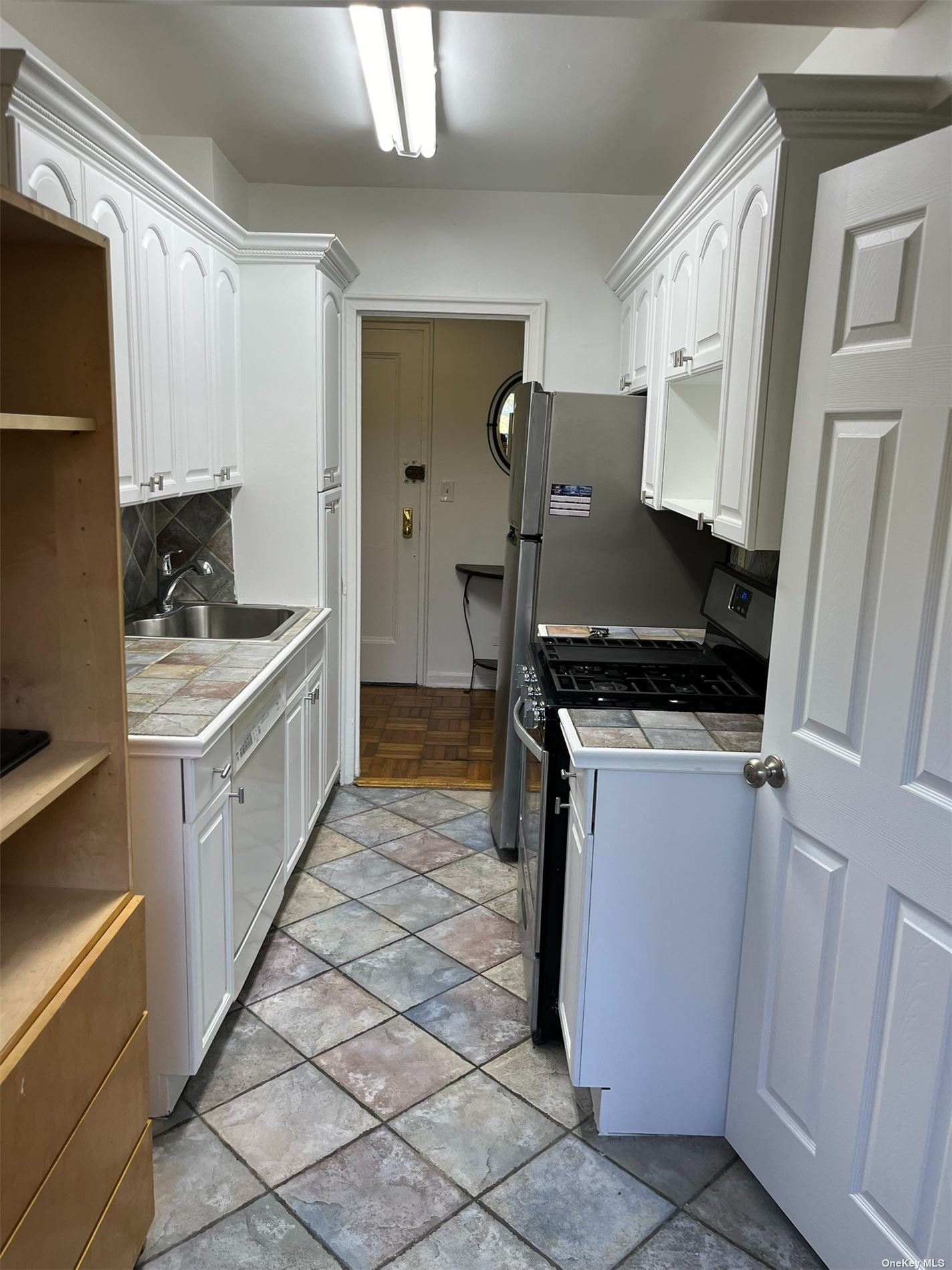 a kitchen with a refrigerator and a stove