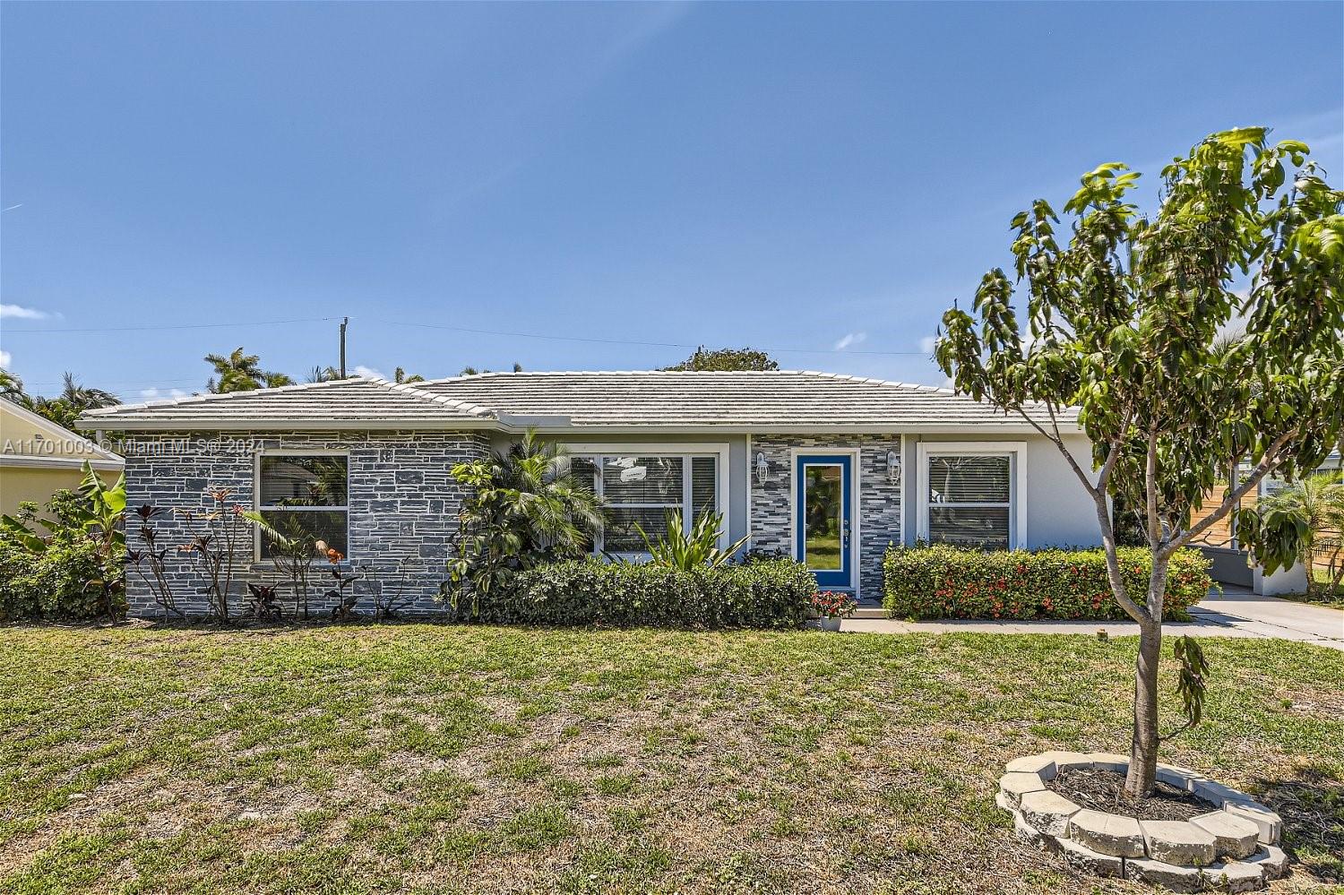 a front view of house with yard and green space