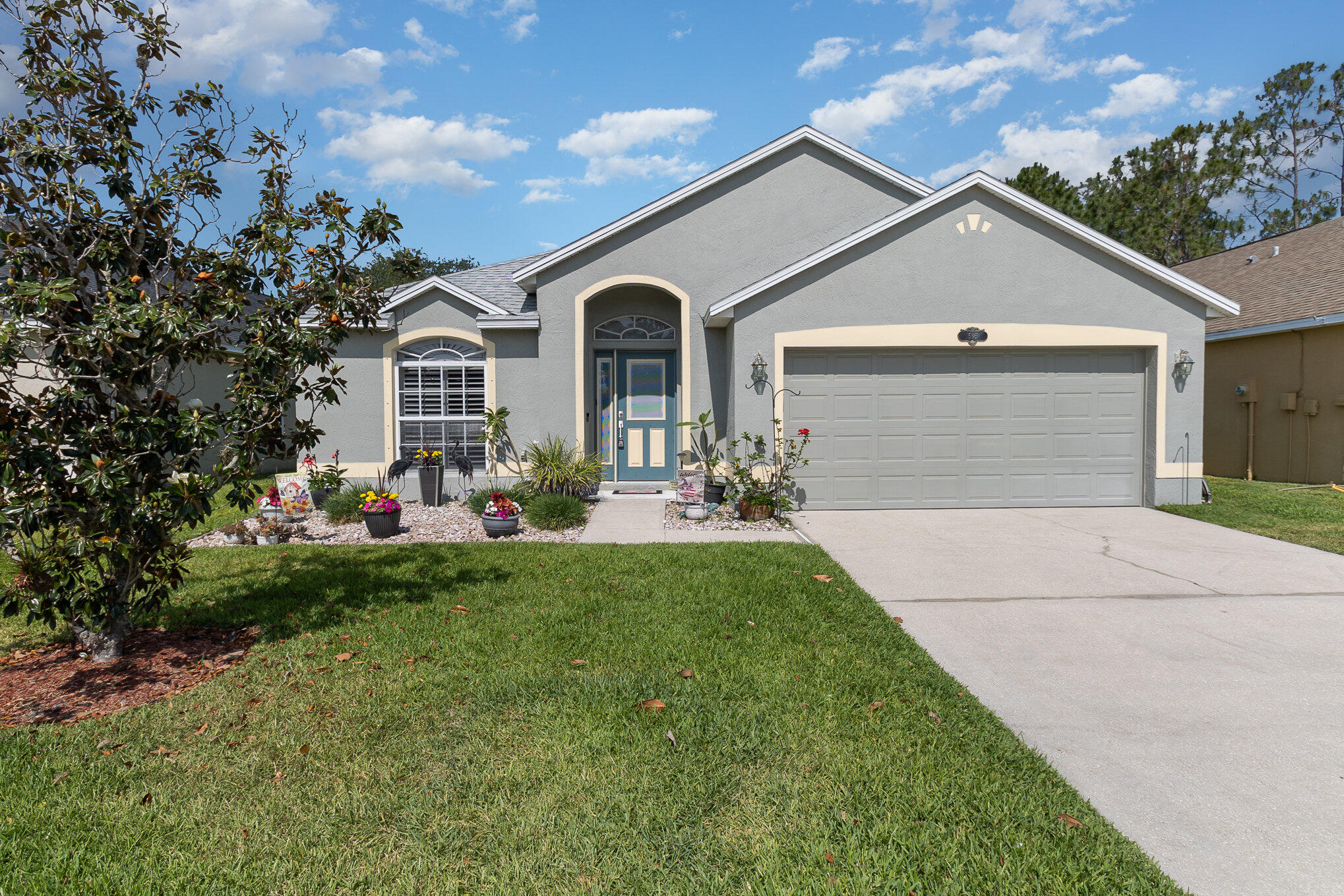 a front view of a house with a yard and garage