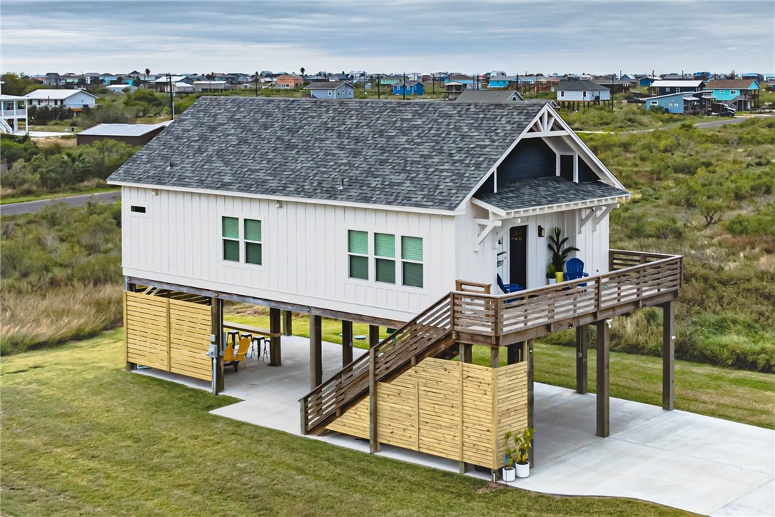 an aerial view of a house with a yard