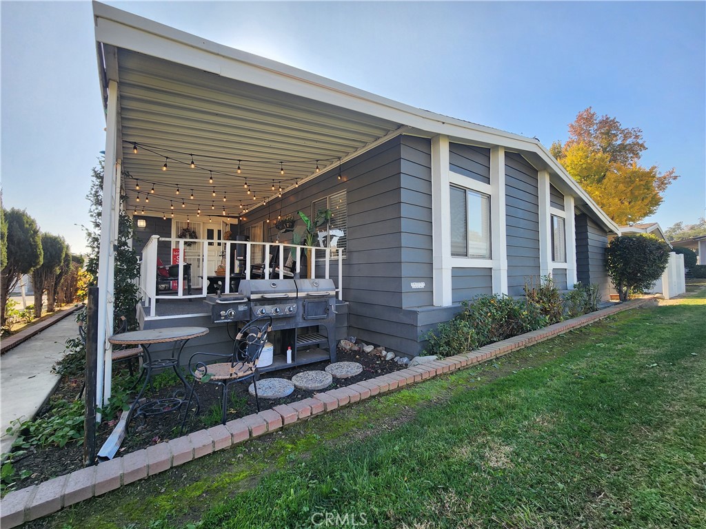 a front view of a house with a garden and patio