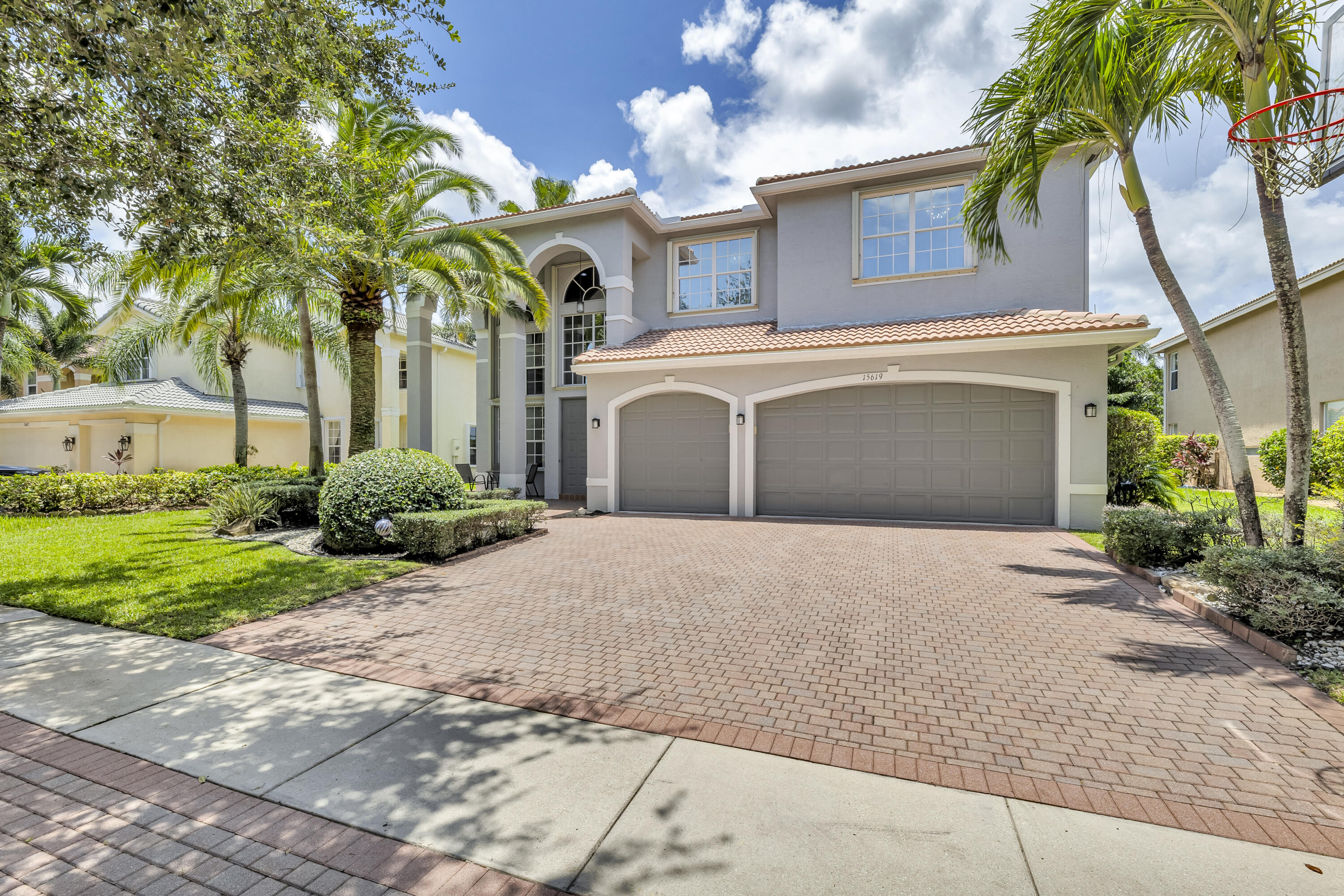 a front view of a house with a yard and a garage