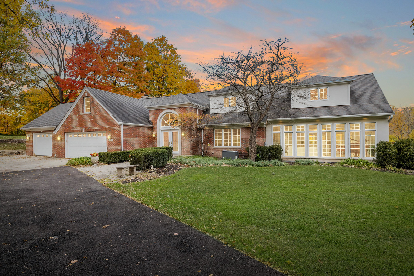 a front view of a house with a garden