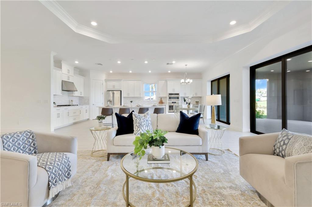 a living room with furniture kitchen view and a table