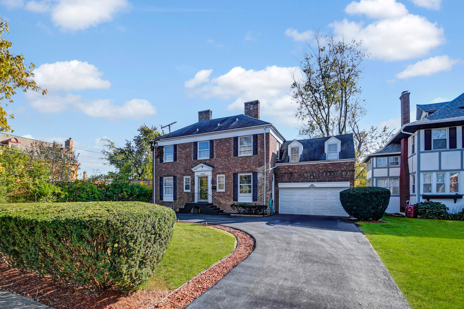 a front view of a house with a garden