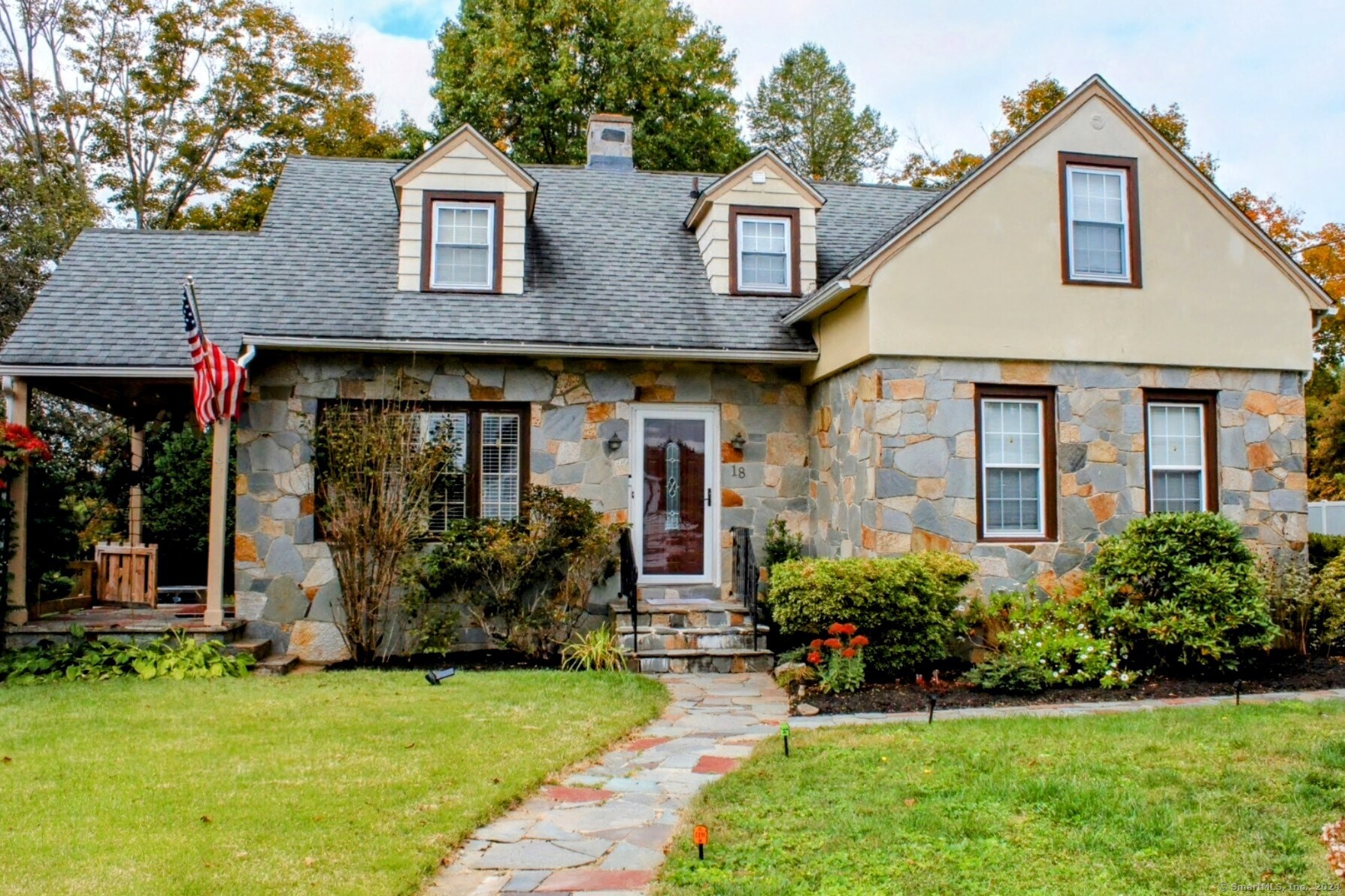 a front view of a house with garden