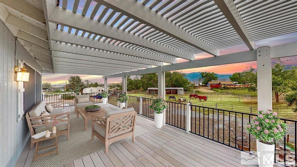 a view of a patio with chairs and floor to ceiling window