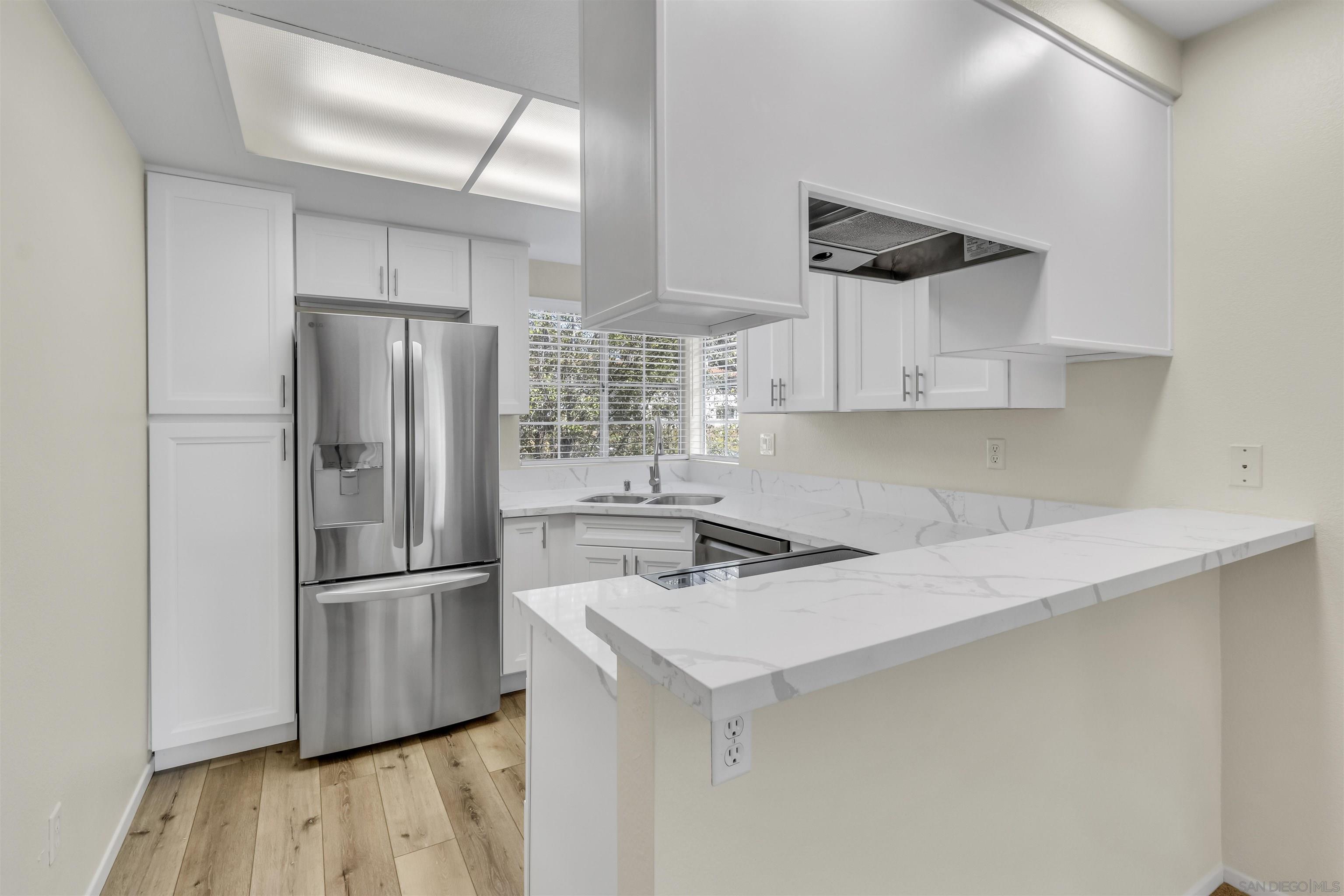 a kitchen with stainless steel appliances a refrigerator and a sink