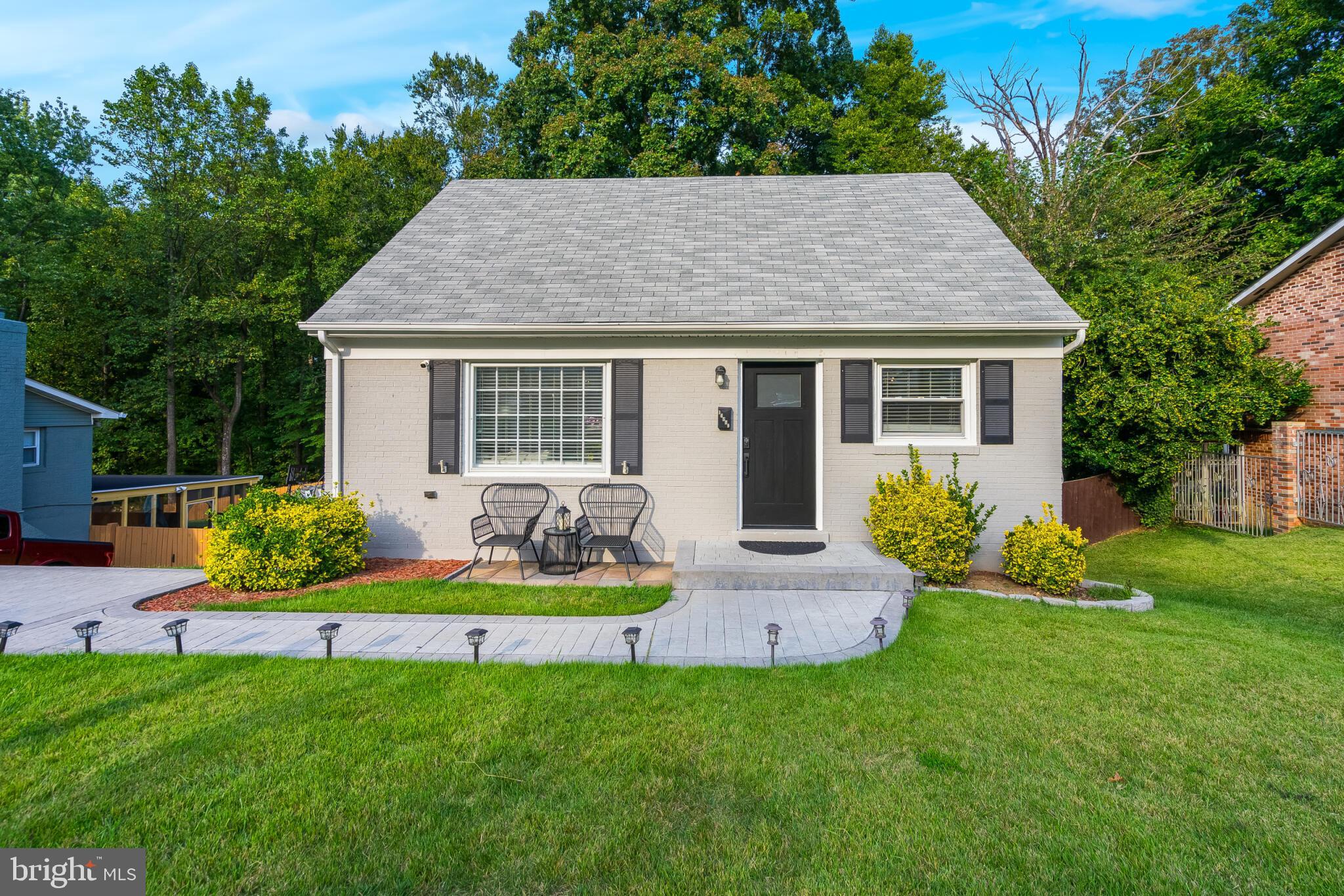 a front view of house with yard and green space