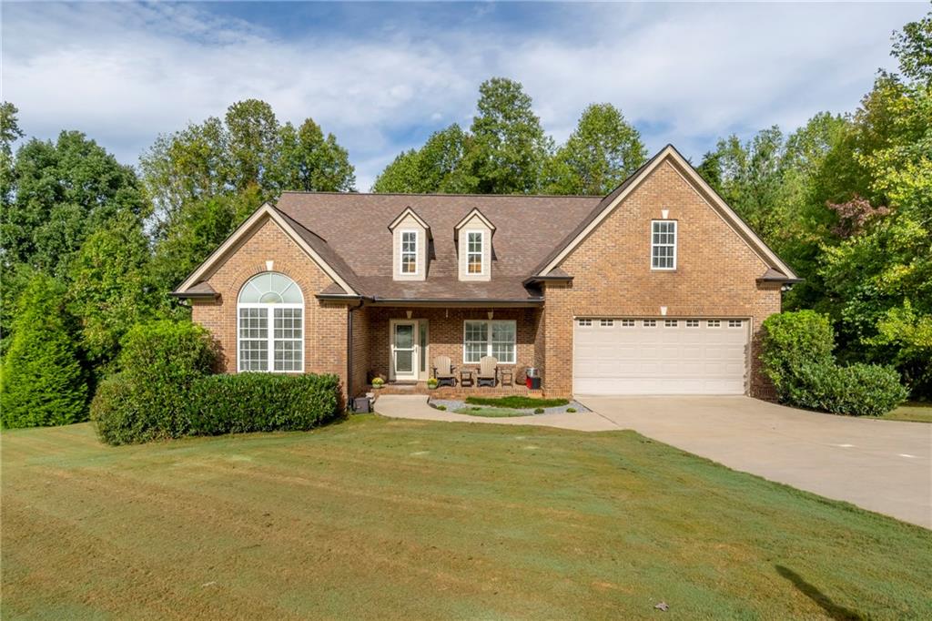 a front view of a house with a yard and garage