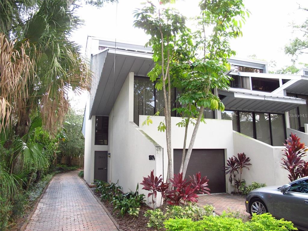 a view of a house with backyard and sitting area