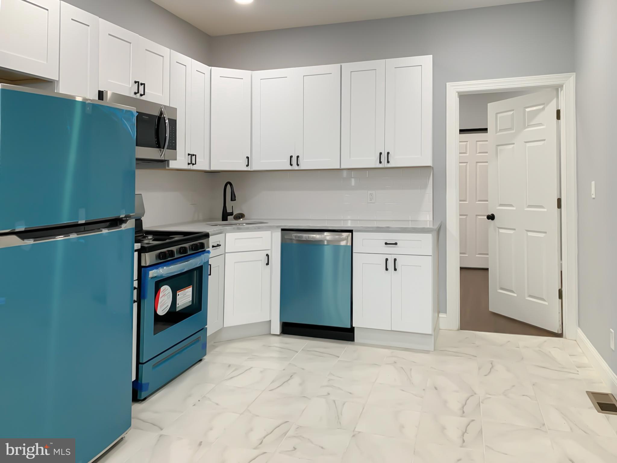 a kitchen with stainless steel appliances a stove and a refrigerator