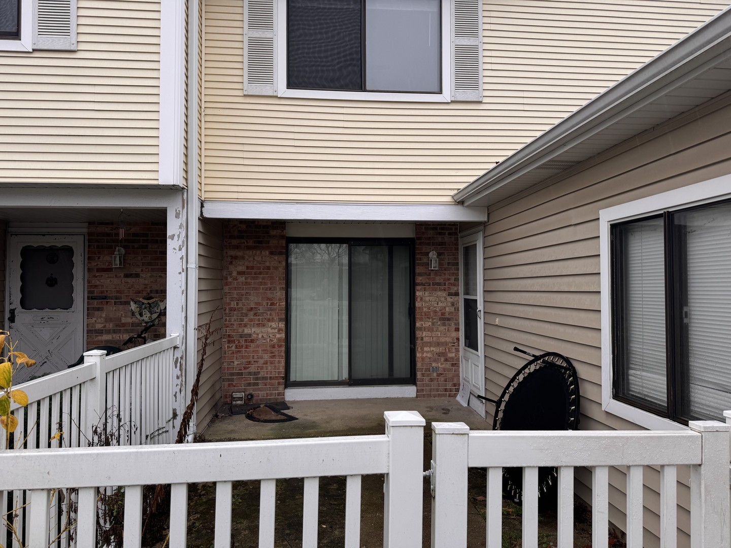 a view of a house with a small deck