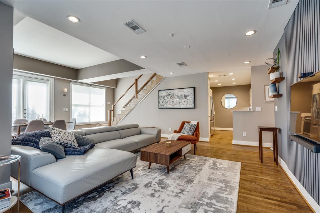 a living room with furniture wooden floor and a rug