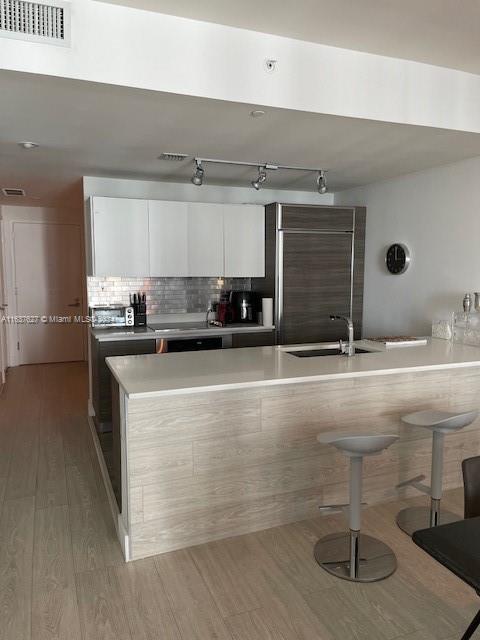 a kitchen with a sink and cabinets