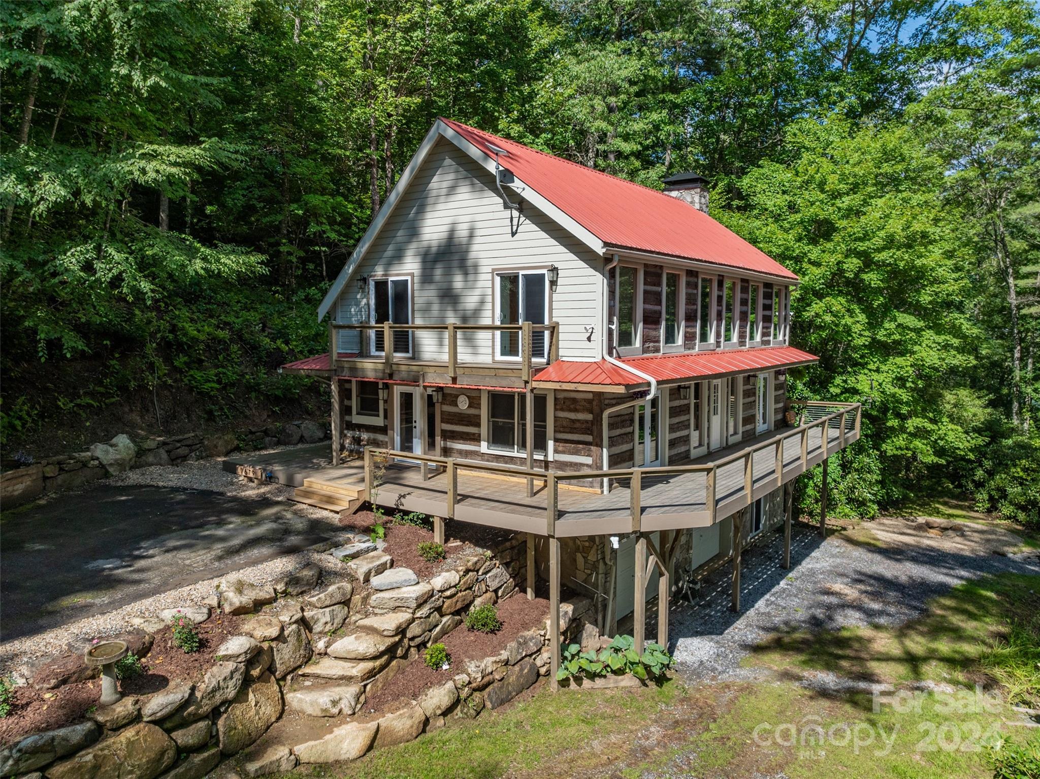 a front view of a house with yard and balcony