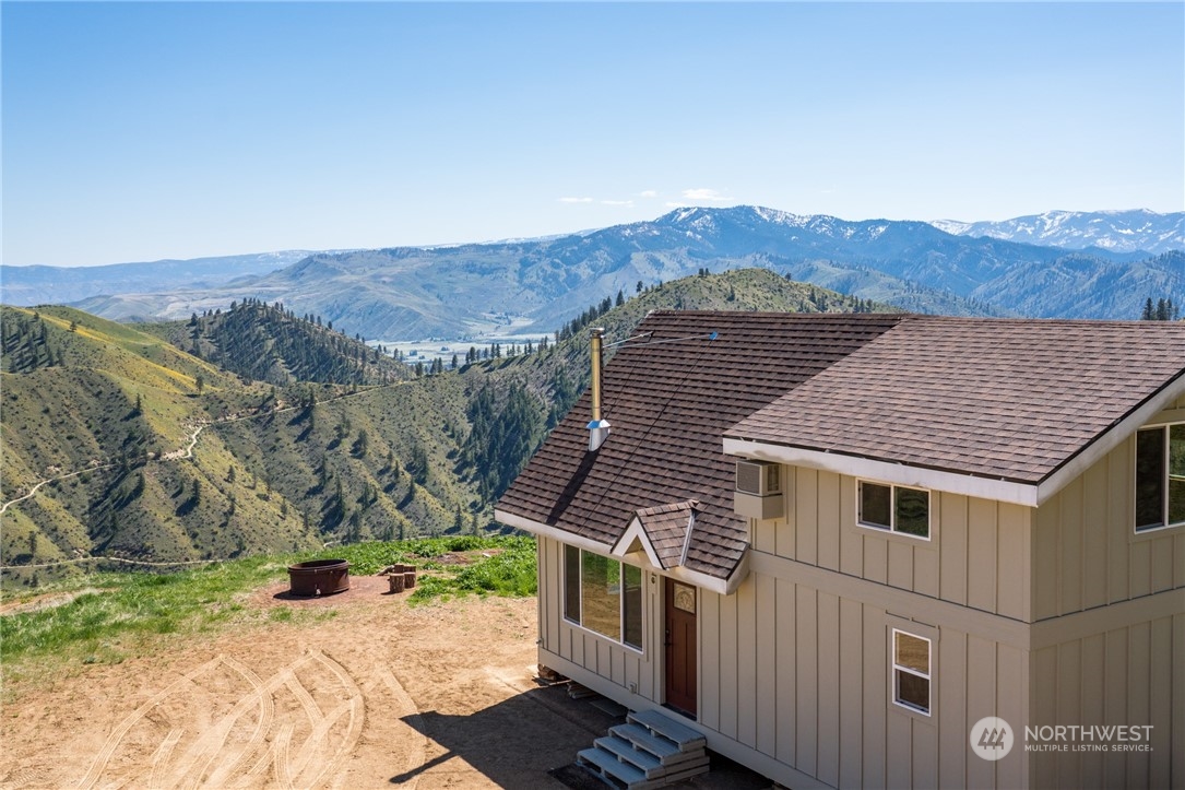 a view of a house with a mountain in the background