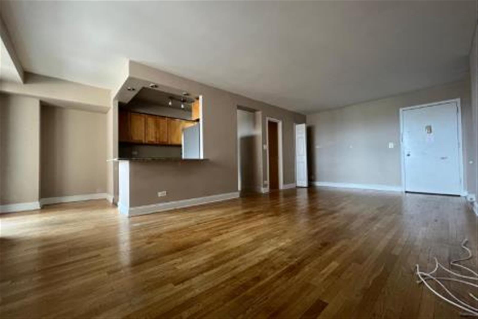 a view of a livingroom with wooden floor