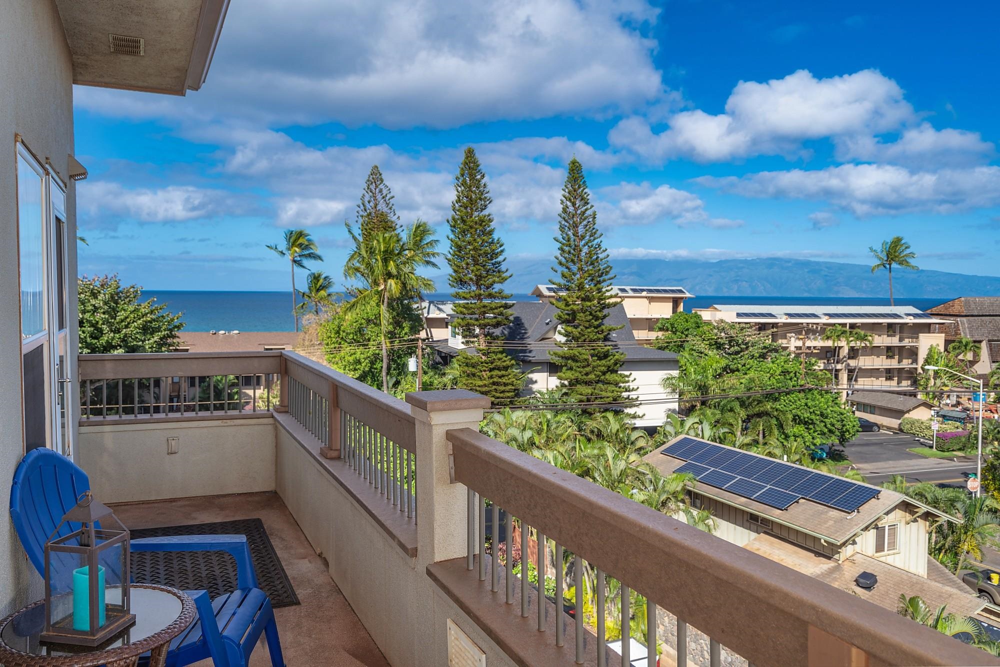 a balcony with wooden floor and outdoor seating