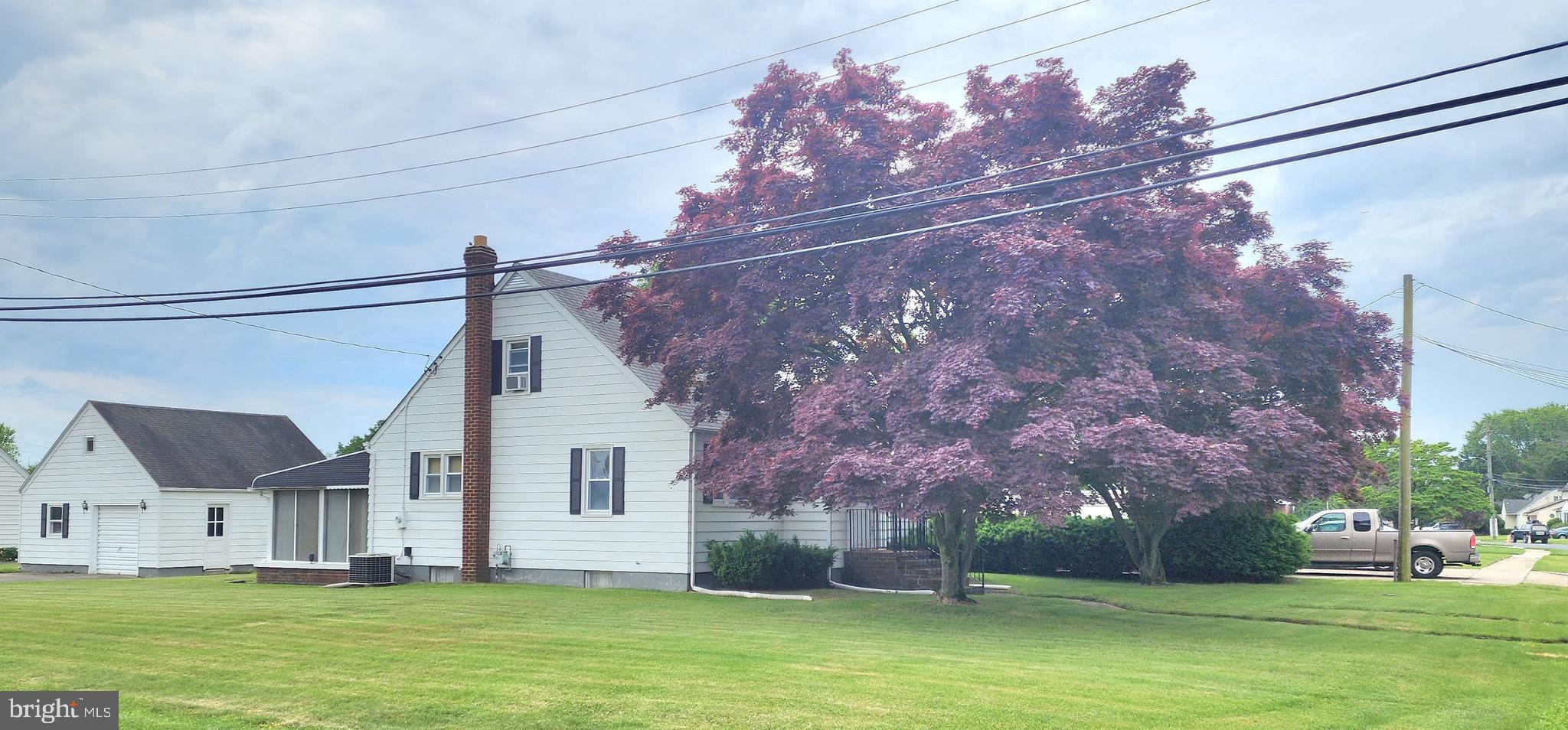 a front view of a house with a garden and yard