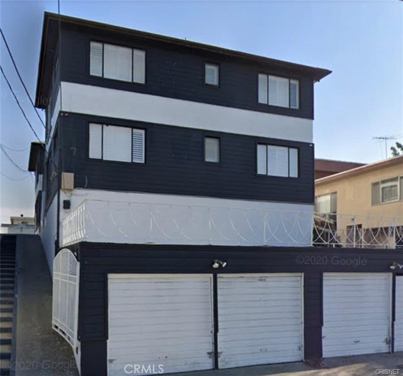 a front view of a house with large windows