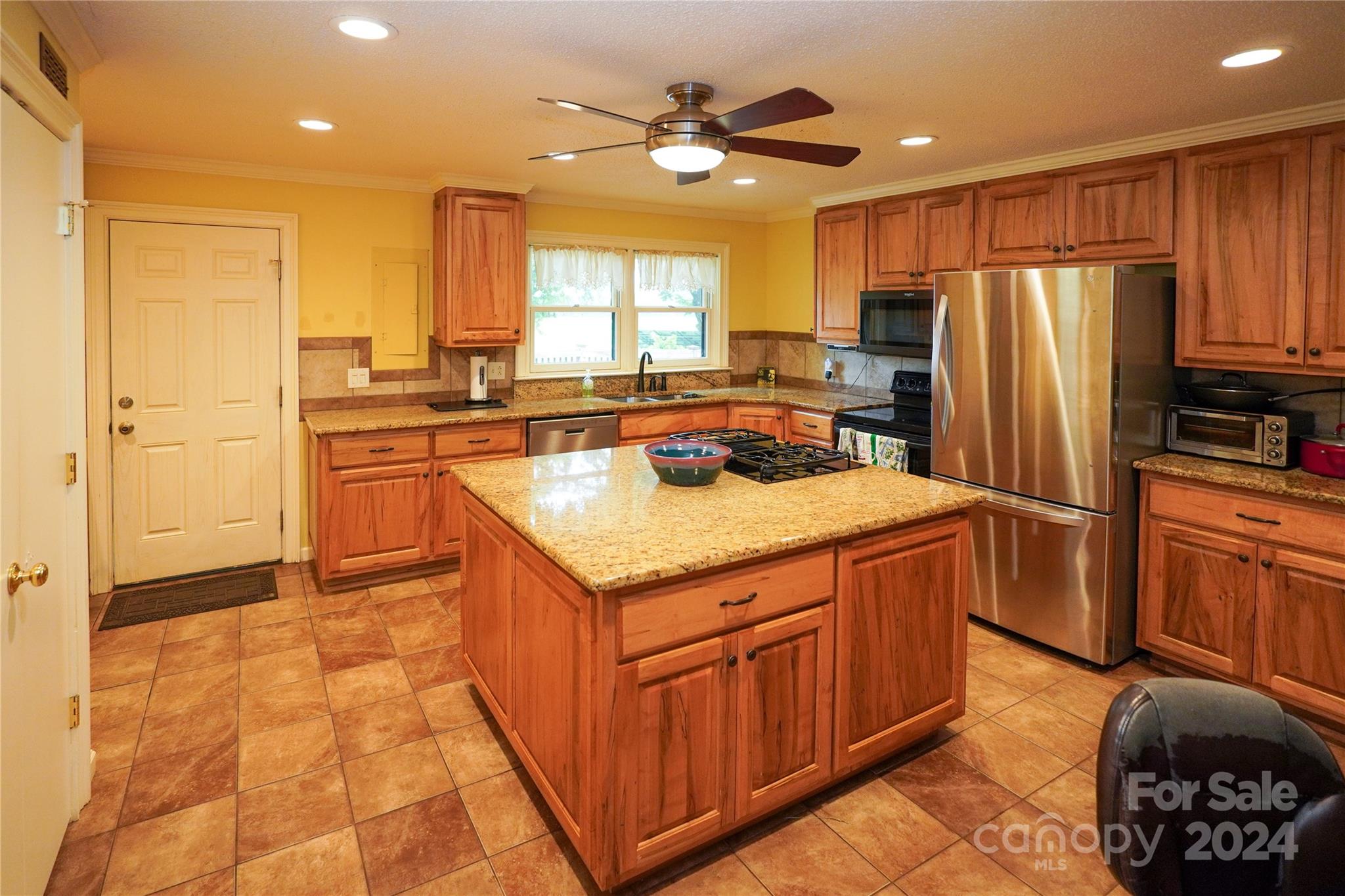 a kitchen with stainless steel appliances granite countertop a sink stove and refrigerator