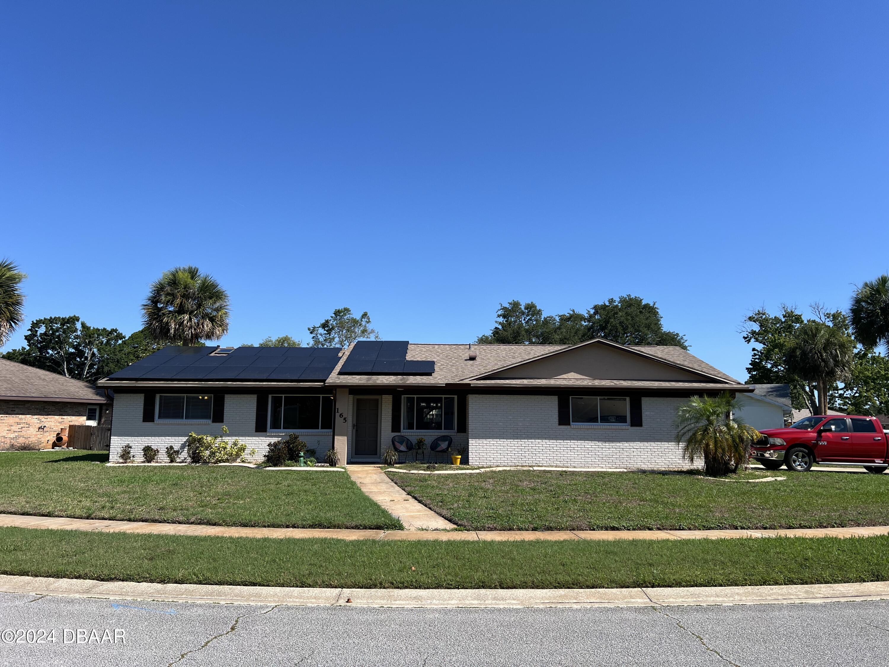 a front view of a house with a garden