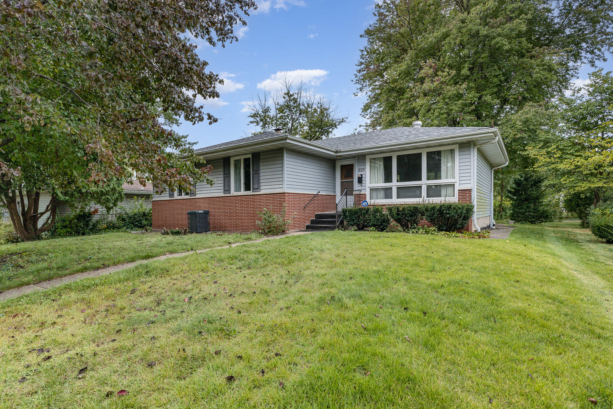 a view of a house with yard and a garden