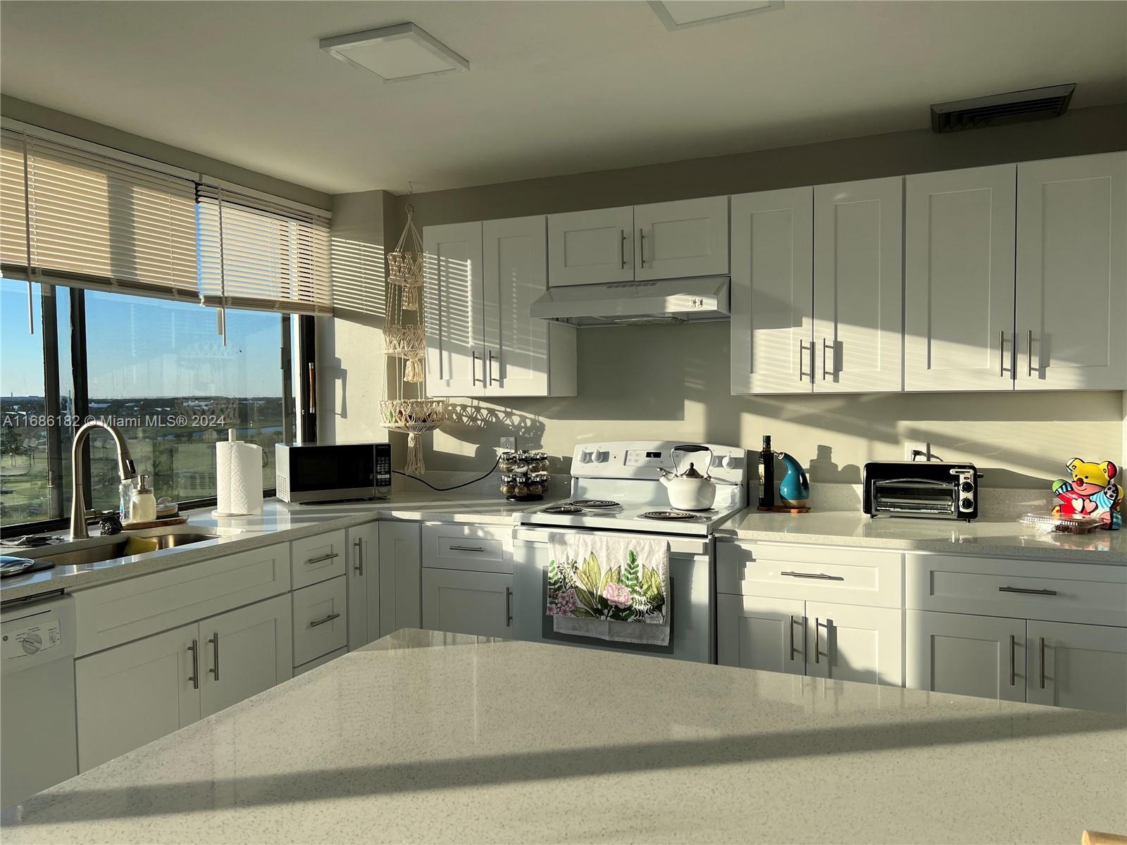 a kitchen with cabinets a sink and appliances