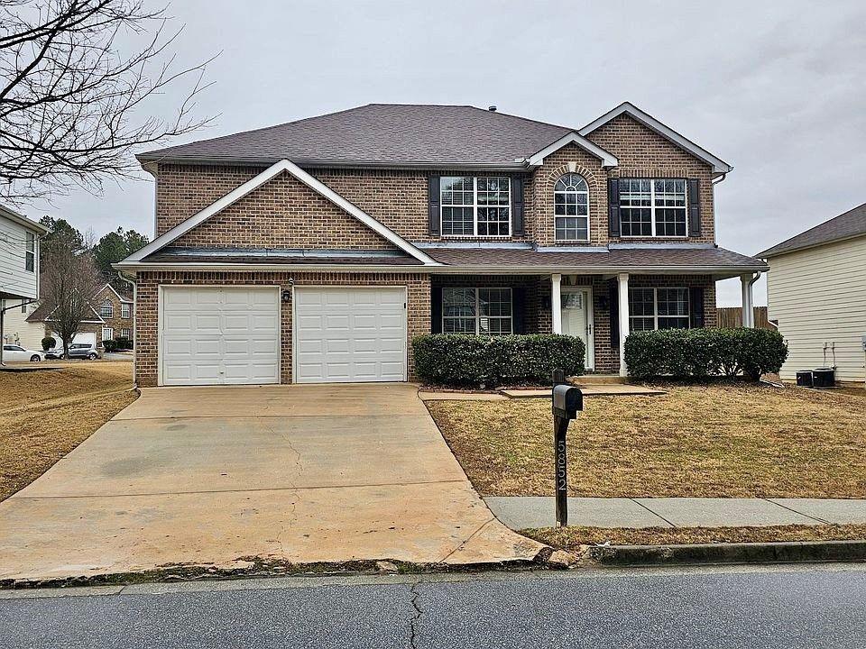 a front view of a house with yard