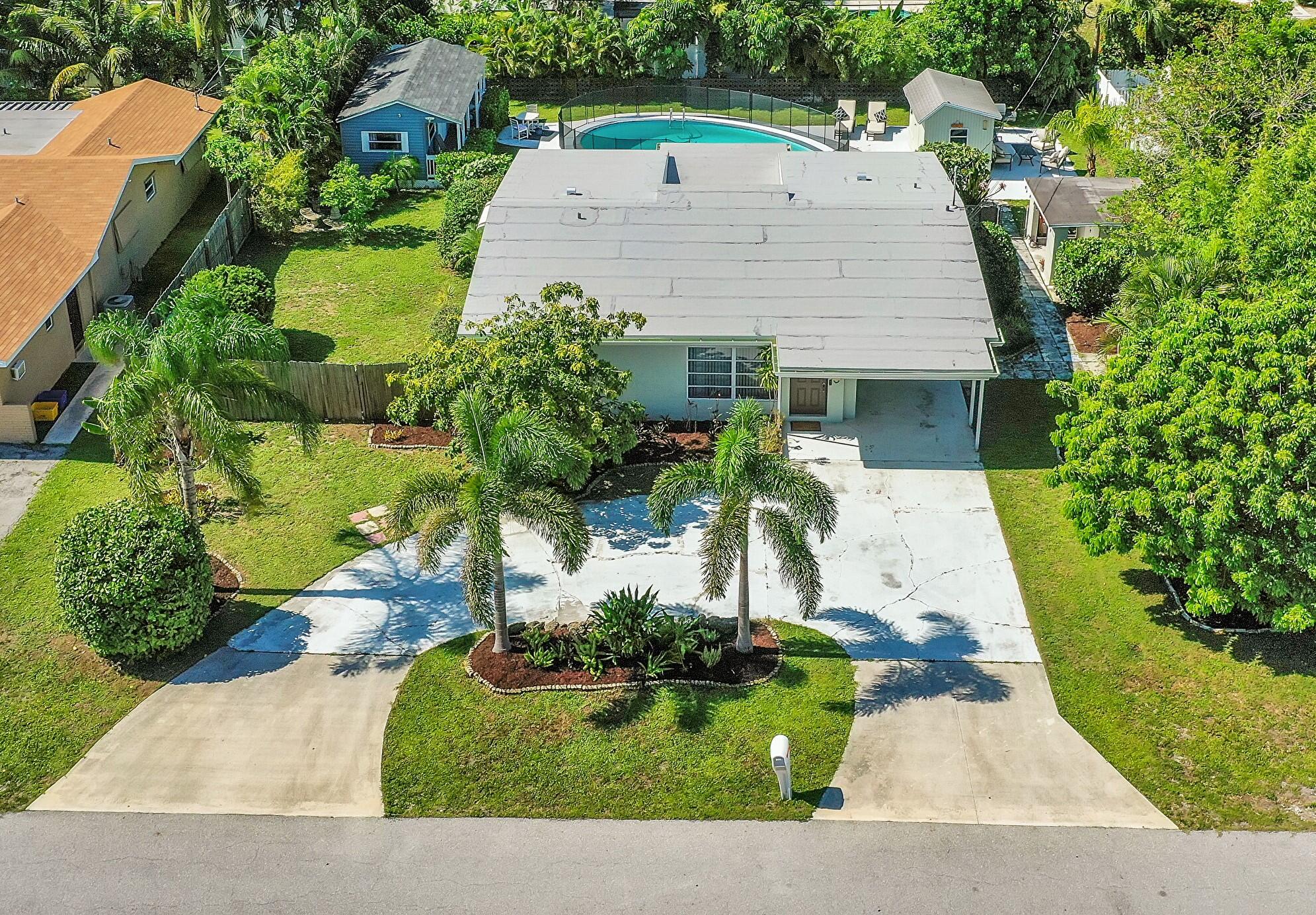 an aerial view of a house with yard