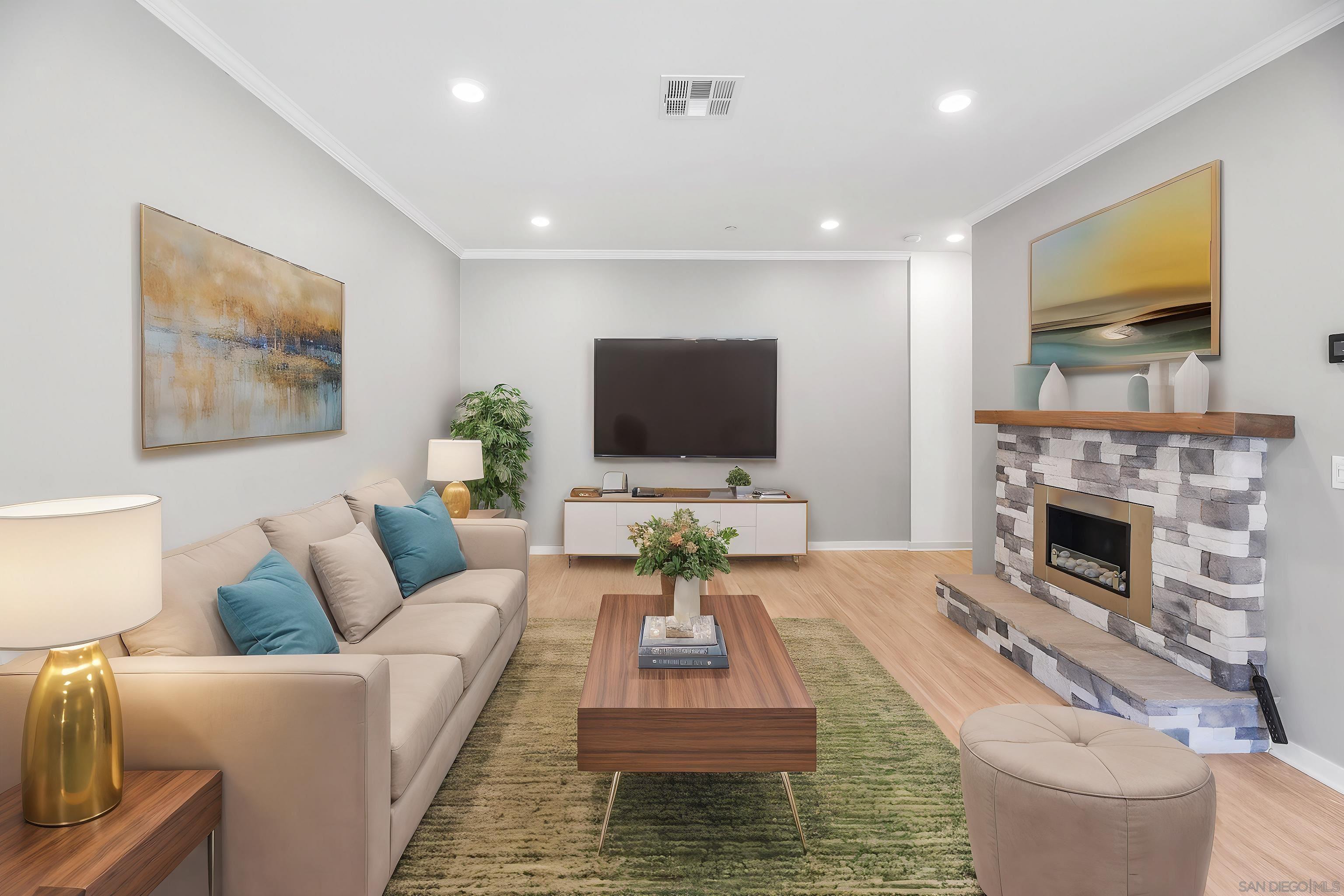 a living room with furniture a flat screen tv and a fireplace