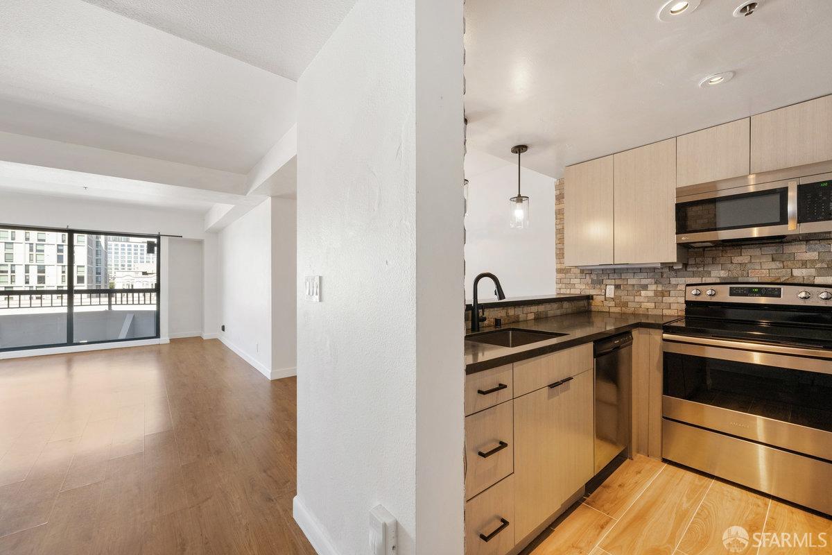 a kitchen with stainless steel appliances granite countertop a stove and a sink