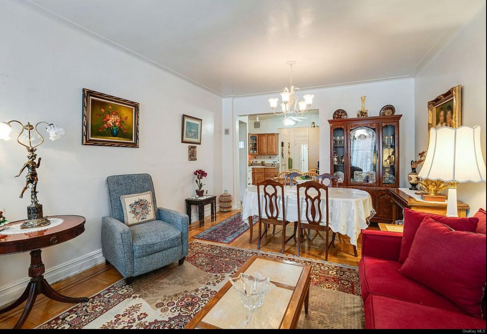 a living room with furniture a dining table and a potted plant