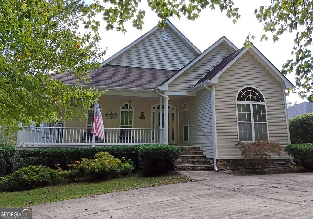 a front view of a house with a garden