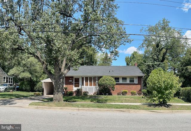 a front view of a house with a yard and potted plants